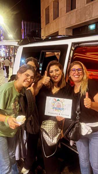 Ομάδα πελατών με πινακίδα Kings World Transfer